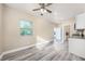 Bright bedroom with wood-look floors and a view of the backyard at 727 N Grandview Ave, Daytona Beach, FL 32118