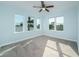 Spacious bedroom with light grey carpeting and large windows at 727 N Grandview Ave, Daytona Beach, FL 32118