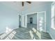 Bright bedroom with French doors, wood-look tile floors, and ample natural light at 727 N Grandview Ave, Daytona Beach, FL 32118