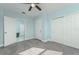Simple bedroom with grey carpet, light blue walls, and a large closet at 727 N Grandview Ave, Daytona Beach, FL 32118