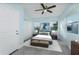 Cozy bedroom with light blue walls, a queen bed, and ample natural light at 727 N Grandview Ave, Daytona Beach, FL 32118