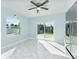 Modern kitchen with white tile flooring, stainless steel appliances, and sliding glass doors at 727 N Grandview Ave, Daytona Beach, FL 32118