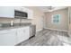 Modern white kitchen with stainless steel appliances and grey countertops at 727 N Grandview Ave, Daytona Beach, FL 32118
