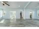 Open living room with hardwood floors, high ceilings, and views of the kitchen and staircase at 727 N Grandview Ave, Daytona Beach, FL 32118