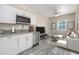 Open living area with white kitchen, stainless steel appliances, and white couch at 727 N Grandview Ave, Daytona Beach, FL 32118
