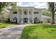 Two story house with manicured lawn and circular driveway at 9102 S Bay Dr, Orlando, FL 32819