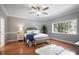 Main bedroom with hardwood floors and large window providing natural light at 9102 S Bay Dr, Orlando, FL 32819