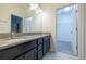 Double vanity bathroom with granite countertop, dark cabinets, and a walk-in closet at 1166 Presidential Ln, Apopka, FL 32703