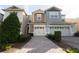 Two-story townhome with two-car garage and landscaped walkway at 1166 Presidential Ln, Apopka, FL 32703