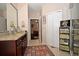 Bathroom with granite countertops, walk-in closet, and modern fixtures at 1341 Arbor Vista Loop # 213, Lake Mary, FL 32746