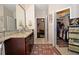 Bathroom with granite countertops, walk-in closet, and modern fixtures at 1341 Arbor Vista Loop # 213, Lake Mary, FL 32746