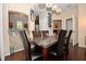 Dining room with dark wood table and six black chairs, and view to kitchen at 1341 Arbor Vista Loop # 213, Lake Mary, FL 32746