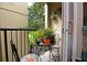 Private balcony with small table and chairs, surrounded by plants at 1341 Arbor Vista Loop # 213, Lake Mary, FL 32746