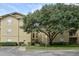 Three-story apartment building with a tree in front at 1341 Arbor Vista Loop # 213, Lake Mary, FL 32746