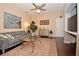 Living room with gray couch, dark hardwood floors, and a large painting at 1341 Arbor Vista Loop # 213, Lake Mary, FL 32746