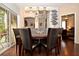 Dining room with dark wood table and six black chairs at 1341 Arbor Vista Loop # 213, Lake Mary, FL 32746