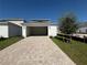 Exterior view of garage with paver driveway at 2007 Iorio St, Saint Cloud, FL 34771