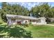 Cute one-story house with a lush green lawn and a two-car garage at 2132 Rouse Lake Rd, Orlando, FL 32817