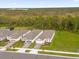 Row of houses with gray roofs, two-car garages, and a wooded backdrop at 2479 Pine Preserve Ct, Saint Cloud, FL 34771