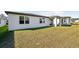 Large backyard with covered patio and grassy area at 28054 Poppy Ct, Leesburg, FL 34748