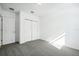 Well-lit bedroom featuring grey carpet and a large window at 28054 Poppy Ct, Leesburg, FL 34748