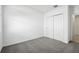 Spacious bedroom with grey carpet and double-door closet at 28054 Poppy Ct, Leesburg, FL 34748