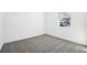 Spacious bedroom with grey carpet, a window with blinds, and white walls at 28054 Poppy Ct, Leesburg, FL 34748