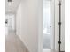 Bright hallway with doors and view into another room at 28054 Poppy Ct, Leesburg, FL 34748