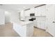 Modern kitchen with white cabinets, stainless steel appliances, and an island at 28054 Poppy Ct, Leesburg, FL 34748