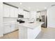 Modern kitchen featuring white cabinets, stainless steel appliances, and a large island at 28054 Poppy Ct, Leesburg, FL 34748