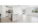 Modern kitchen with white cabinets, stainless steel appliances, and an island at 28054 Poppy Ct, Leesburg, FL 34748