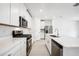 Bright kitchen with white cabinets, stainless steel appliances, and tile flooring at 28054 Poppy Ct, Leesburg, FL 34748