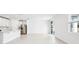 Open-concept kitchen with white cabinets, stainless steel appliances, and sliding glass doors at 28054 Poppy Ct, Leesburg, FL 34748