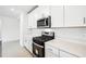 Modern kitchen with stainless steel appliances and white cabinetry at 28054 Poppy Ct, Leesburg, FL 34748