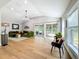 Cozy living room with a green velvet sofa, sliding glass doors to the backyard, wood floors, and abundant natural light at 3701 Wyldwoode Ln, Orlando, FL 32806