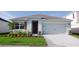 Single-story home with two-car garage and landscaped lawn at 3863 Rory Pond Ct, Lakeland, FL 33811