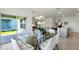 Dining area with glass-top table, white chairs, and sliding door access to patio at 3863 Rory Pond Ct, Lakeland, FL 33811