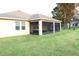 House exterior with screened porch and grassy backyard at 4420 Heritage Trl, Leesburg, FL 34748