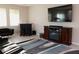 Living room with a built-in electric fireplace and large TV at 4420 Heritage Trl, Leesburg, FL 34748