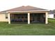 House exterior showcasing a screened porch and backyard at 4420 Heritage Trl, Leesburg, FL 34748
