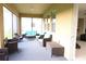 Relaxing screened porch with wicker furniture and room for a grill at 4420 Heritage Trl, Leesburg, FL 34748