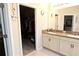 Double vanity bathroom with a large closet at 4420 Heritage Trl, Leesburg, FL 34748