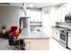 Spacious kitchen with granite counters, island, and stainless steel appliances at 4420 Heritage Trl, Leesburg, FL 34748