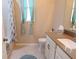 Updated bathroom with a tub, toilet, vanity, and new flooring at 4420 Heritage Trl, Leesburg, FL 34748