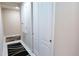 Long hallway with neutral walls, tile flooring, and access to other rooms at 4420 Heritage Trl, Leesburg, FL 34748