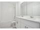 Bathroom with double vanity, white cabinets, and a bathtub at 4706 Jasmine Cir, Leesburg, FL 34748