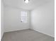 Simple bedroom with gray carpet and a window at 4706 Jasmine Cir, Leesburg, FL 34748