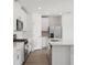 White kitchen with stainless steel appliances and an island at 4706 Jasmine Cir, Leesburg, FL 34748