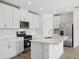 Modern kitchen featuring stainless steel appliances and white cabinetry at 4706 Jasmine Cir, Leesburg, FL 34748