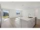 Open floor plan with kitchen island, stainless steel appliances, and view of backyard at 4706 Jasmine Cir, Leesburg, FL 34748